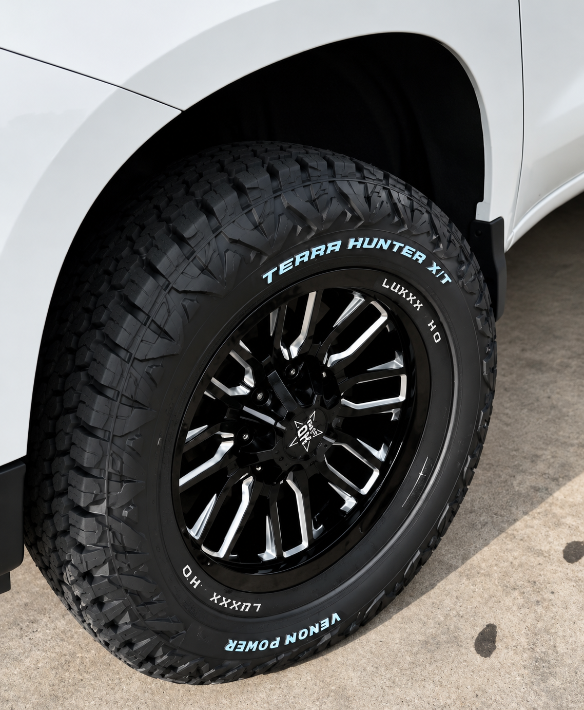 Same SUV after new tires and black custom wheels were installed