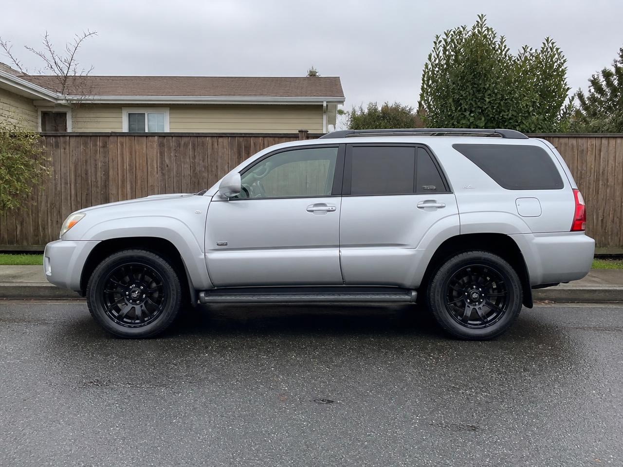 Same SUV after new tires and black custom wheels were installed