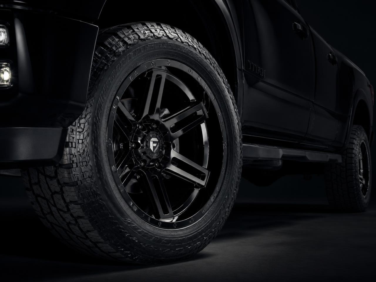 Close-up of a black custom truck wheel with a new all-terrain tire